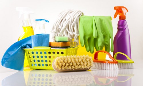 Cleaner preparing carpet cleaning equipment in a safe working environment